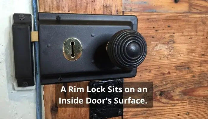 A Rim Lock Sits on an Inside Door's Surface